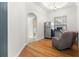 Bright breakfast room with hardwood floors, chair, and refrigerator at 6045 Se 99Th Pl, Belleview, FL 34420