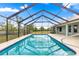 Sparkling screened-in pool featuring ample space for relaxation and outdoor enjoyment at 6045 Se 99Th Pl, Belleview, FL 34420