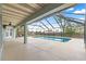 Inviting covered and screened-in pool with generous patio space for outdoor relaxation and activities at 6045 Se 99Th Pl, Belleview, FL 34420
