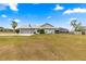 Single-story home featuring an attached garage, screened in lanai, and ample backyard space for outdoor activities at 6045 Se 99Th Pl, Belleview, FL 34420