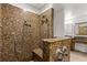 Oversized walk-in shower with dual shower heads and stone surround at 6045 Se 99Th Pl, Belleview, FL 34420