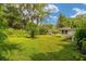 Expansive grassy backyard with mature trees, offering privacy and outdoor space at 608 Se 31St Ter, Ocala, FL 34471