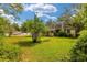 Home with backyard and green grass at 608 Se 31St Ter, Ocala, FL 34471