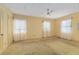 Spacious bedroom with natural light, featuring carpeted floors and a ceiling fan at 608 Se 31St Ter, Ocala, FL 34471