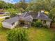 Aerial shot showing a ranch-style home with an ashpalt shingle roof and mature greenery at 608 Se 31St Ter, Ocala, FL 34471