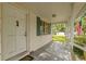 Inviting front porch with vintage details and an American flag, perfect for enjoying the outdoors at 608 Se 31St Ter, Ocala, FL 34471