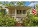 A classic front porch with American flag, perfect for relaxing and enjoying the neighborhood at 608 Se 31St Ter, Ocala, FL 34471
