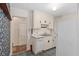 Classic kitchen featuring white cabinets, blue tiled floor, and a vintage aesthetic at 608 Se 31St Ter, Ocala, FL 34471