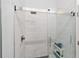 Modern bathroom with a glass-enclosed shower and white tiled walls at 716 Se Wenona Ave, Ocala, FL 34471