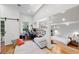 Bright bedroom featuring a work space, hardwood floors and an ensuite bedroom separated by a half wall at 716 Se Wenona Ave, Ocala, FL 34471