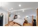Cozy bedroom with hardwood floors, a comfortable bed, and natural light through a window at 716 Se Wenona Ave, Ocala, FL 34471
