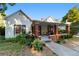 Inviting two-story home with lush landscaping, brick columns, and a cozy front porch at 716 Se Wenona Ave, Ocala, FL 34471