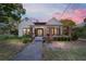 Charming home with a covered front porch, brick pillars, and a well-maintained landscaped yard at 716 Se Wenona Ave, Ocala, FL 34471