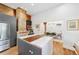 Open kitchen with exposed brick accent and large island adjacent to the dining area at 716 Se Wenona Ave, Ocala, FL 34471