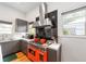 Updated kitchen features modern appliances, gray cabinets, and a unique orange oven range at 716 Se Wenona Ave, Ocala, FL 34471