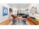 Open-concept living room with hardwood floors, unique artwork, and modern furniture at 716 Se Wenona Ave, Ocala, FL 34471