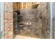 Close up of shower stall showing brick details, gray marble tile and multiple shower heads at 716 Se Wenona Ave, Ocala, FL 34471