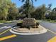 Stone sign that reads 'Juliette Falls', situated among manicured shrubs and trees at the community entrance at 7781 Sw 180Th Cir, Dunnellon, FL 34432
