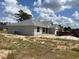 New construction home with gray siding, a gray roof, and a two-car garage on a sunny day at 7781 Sw 180Th Cir, Dunnellon, FL 34432