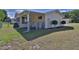 Fenced backyard featuring an enclosed porch and a well-maintained lawn at 8443 Sw 109Th Place, Ocala, FL 34481