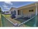 Enclosed back porch featuring patio furniture, ideal for outdoor relaxation and entertaining at 8443 Sw 109Th Place, Ocala, FL 34481