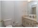 Bathroom features a toilet and vanity with neutral counter at 8443 Sw 109Th Place, Ocala, FL 34481