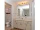 Bright bathroom featuring a vanity with ample storage, a large mirror, and a toilet at 8443 Sw 109Th Place, Ocala, FL 34481