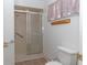 Bathroom with a tiled shower featuring sliding glass doors and a showerhead at 8443 Sw 109Th Place, Ocala, FL 34481