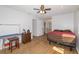Bedroom with hardwood floors and a ceiling fan leads to the ensuite bathroom at 8443 Sw 109Th Place, Ocala, FL 34481