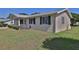 A single story home with siding and green shutters on a sunny day at 8443 Sw 109Th Place, Ocala, FL 34481