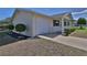 A light colored home with an attached garage, tidy landscaping, and a paved walkway at 8443 Sw 109Th Place, Ocala, FL 34481