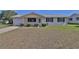 Charming single-story home featuring a well-maintained lawn and a welcoming front porch at 8443 Sw 109Th Place, Ocala, FL 34481