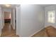 Hallway leading to front door and bedrooms with wood floors at 8443 Sw 109Th Place, Ocala, FL 34481