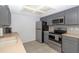 Kitchen features stainless steel appliances, gray cabinets, a tile floor and neutral countertops at 8443 Sw 109Th Place, Ocala, FL 34481