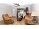 Comfortable living room featuring a ceiling fan, front door and neutral decor at 8443 Sw 109Th Place, Ocala, FL 34481
