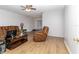 Inviting living room with wood laminate flooring, ceiling fan, and comfortable seating at 8443 Sw 109Th Place, Ocala, FL 34481