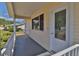 A covered porch with decorative trim and a door with leaded glass is shown at 8443 Sw 109Th Place, Ocala, FL 34481