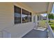A porch is shown featuring a full railing and entrance to the home at 8443 Sw 109Th Place, Ocala, FL 34481