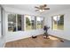 Bright sunroom with wood floors, ceiling fan and multiple windows overlooking the backyard at 8443 Sw 109Th Place, Ocala, FL 34481