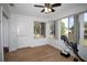 Sunroom with multiple windows overlooking fenced backyard, wood floors and ceiling fan at 8443 Sw 109Th Place, Ocala, FL 34481