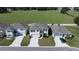 Aerial view of three homes, showcasing their layout and proximity to green spaces at 8617 Triumph Cir, Wildwood, FL 34785
