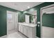 An inviting bathroom featuring a double sink vanity, a large mirror, and an connecting door to the bedroom at 8617 Triumph Cir, Wildwood, FL 34785
