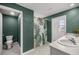 A bathroom with a leaf-themed shower curtain, double sink vanity, and neutral tile flooring at 8617 Triumph Cir, Wildwood, FL 34785