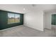 A bedroom with white walls, a large window letting in ample natural light, and neutral carpet flooring at 8617 Triumph Cir, Wildwood, FL 34785