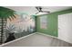 Bright bedroom featuring a vibrant mural, ceiling fan, and a large window letting in ample natural light at 8617 Triumph Cir, Wildwood, FL 34785