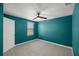 A bedroom with blue walls, a ceiling fan, and a large window letting in ample natural light at 8617 Triumph Cir, Wildwood, FL 34785