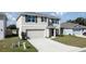 Charming two-story house with a well-maintained lawn and a paved driveway at 8617 Triumph Cir, Wildwood, FL 34785