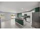 Open-concept kitchen with stainless steel appliances and a spacious island at 8617 Triumph Cir, Wildwood, FL 34785