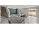 Kitchen island with stainless steel faucet, tile flooring, and an open floorplan at 8617 Triumph Cir, Wildwood, FL 34785