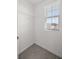 A walk-in closet with white shelving and a sunlit window providing ample storage at 8617 Triumph Cir, Wildwood, FL 34785
